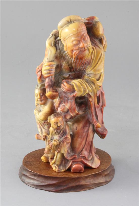 A Chinese soapstone group of an immortal and two attendants, 19th century, 17.5cm high